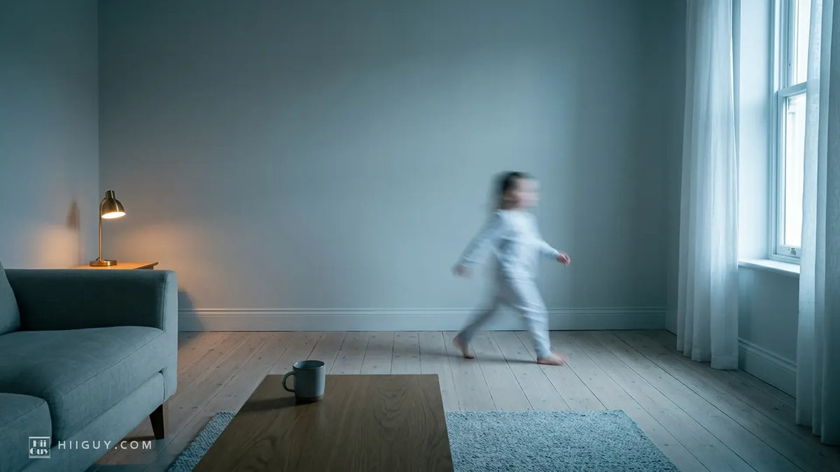 A dim blue-gray living room photographed tack sharp in early morning light, with a small child in pale pajamas crossing the floor as a soft streak of motion blur and a lit brass table lamp at the left.