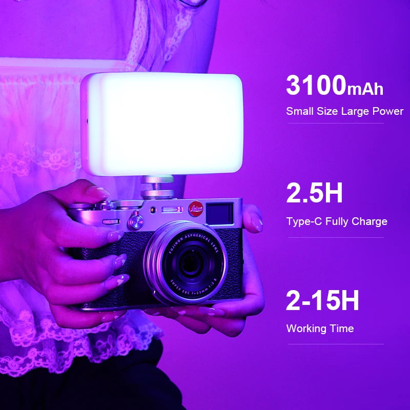 White pocket LED light with a small color screen, shown glowing in rainbow colors, with a diffuser cap, mount and cable