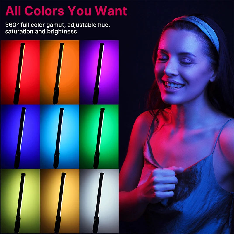 Seven black tube-shaped LED light wands glowing green, yellow, red, orange and blue on a pink and blue background