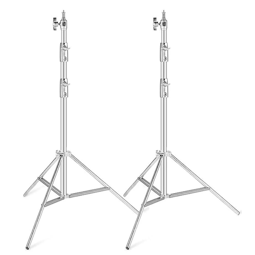 Two silver stainless steel light stands with spread legs, leg braces and adjustable knobs on each section