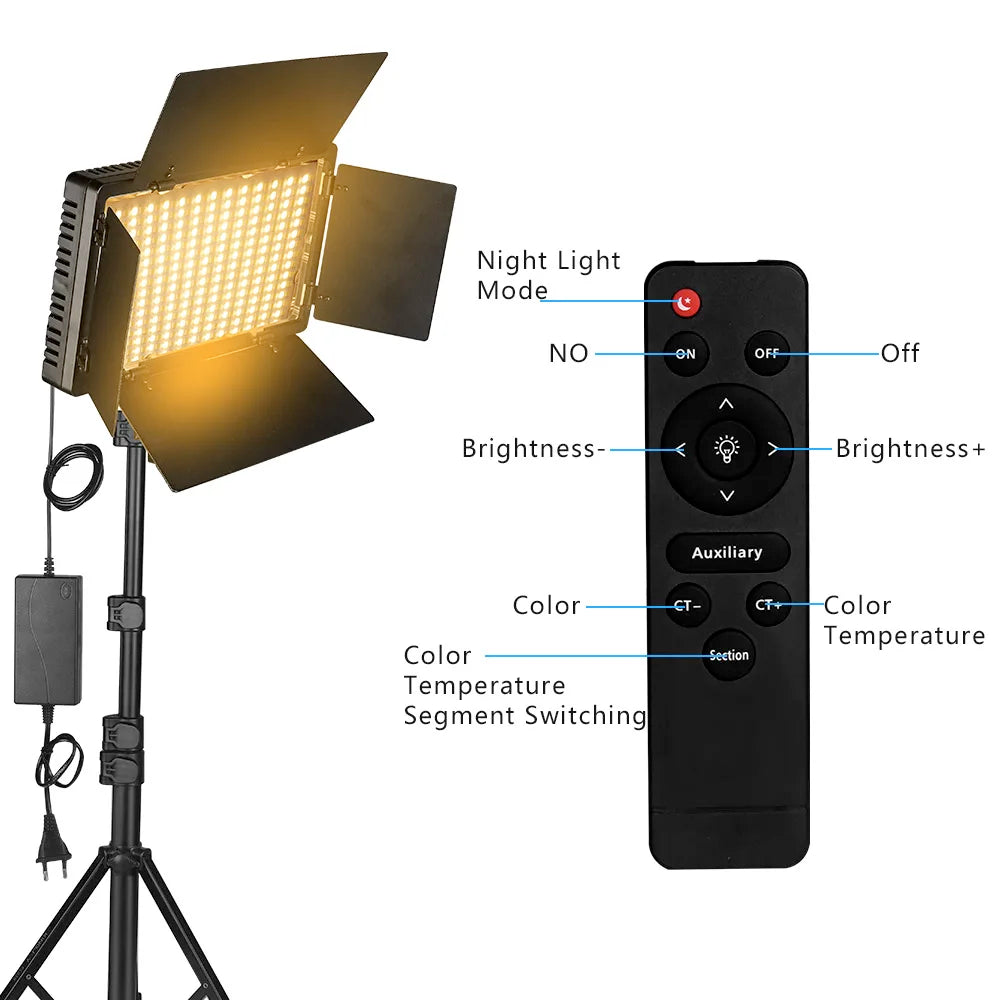 Two LED panel lights with barn doors on tall tripod stands, one lit warm, with power adapters, a remote and a battery