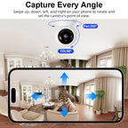White Fuers pan-tilt indoor camera beside a hand holding a phone that shows a sleeping baby in the app