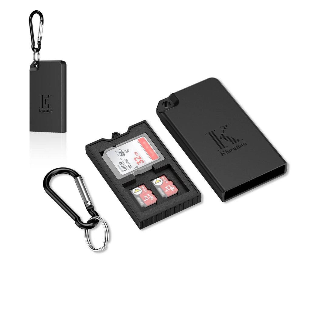 Black Kiorafoto pop-up card case open with an SD card and two microSD cards in its slots, shown with a carabiner