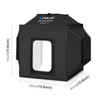 Black Puluz folding light box lit white inside with a necklace on a bust, a camera in hand, four backdrop rolls and EU plug