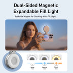 Silver and white Telesin magnetic phone grip with a flip-up disc, shown on a small tripod and with a hand-held remote