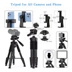 Black tripod with padded legs, a pan head and handle, shown with a phone holder, a DSLR, a spare plate and a folded view