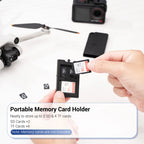 Black Kiorafoto pop-up card case open with an SD card and two microSD cards in its slots, shown with a carabiner