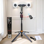 Black and orange selfie stick tripod holding a phone between two round fill lights, with a small remote and folded views
