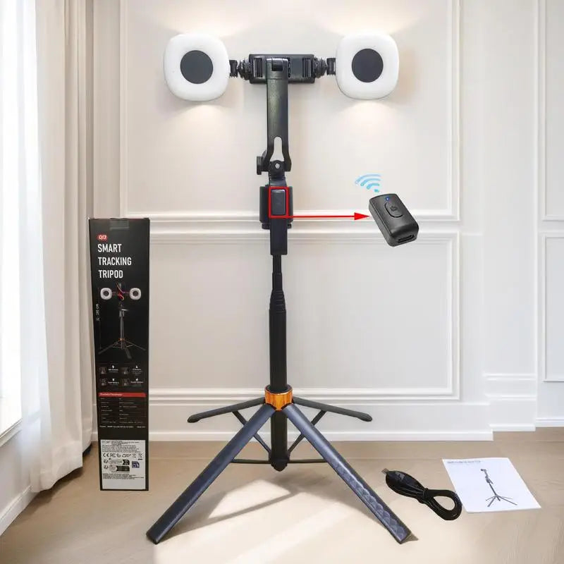 Black and orange selfie stick tripod holding a phone between two round fill lights, with a small remote and folded views
