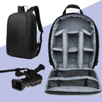 Small black camera backpack shown open with orange padded dividers holding a camera and lenses, with back and side views
