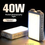 Two pocket-sized LED panel lights with control dials, one champagne and one grey, glowing warm white on a dark surface