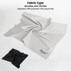 Hand holding a large black microfiber cloth, with a black and a gray cloth in sleeves and a gray retail package below