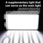 A white pocket-sized LED panel light glowing warm white, held in one hand against a dark background