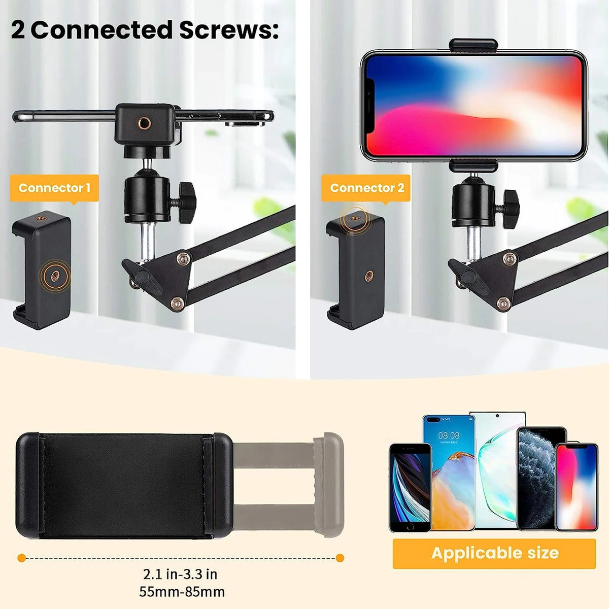 Black spring-loaded desk arm clamped to a table holding a phone, with a remote, ball head, phone clip and clamp laid out