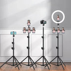 Two black telescoping tripod stands with spread legs, one bare and one holding a phone on a small ball head