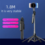 Black phone tripod extended on its legs with a smartphone on top and a remote on the pole, plus a folded one beside it