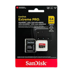 A SanDisk Extreme Pro 128GB microSD card and a SanDisk Extreme card in a black SD adapter on a pink background