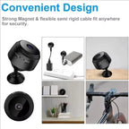 Four round black mini cameras with a magnetic stand and USB cable, next to a phone showing a street view in the app