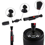 Camera cleaning kit on a shelf: black air blower, lens pen, soft brush, empty spray bottle, cloth and gray drawstring pouch