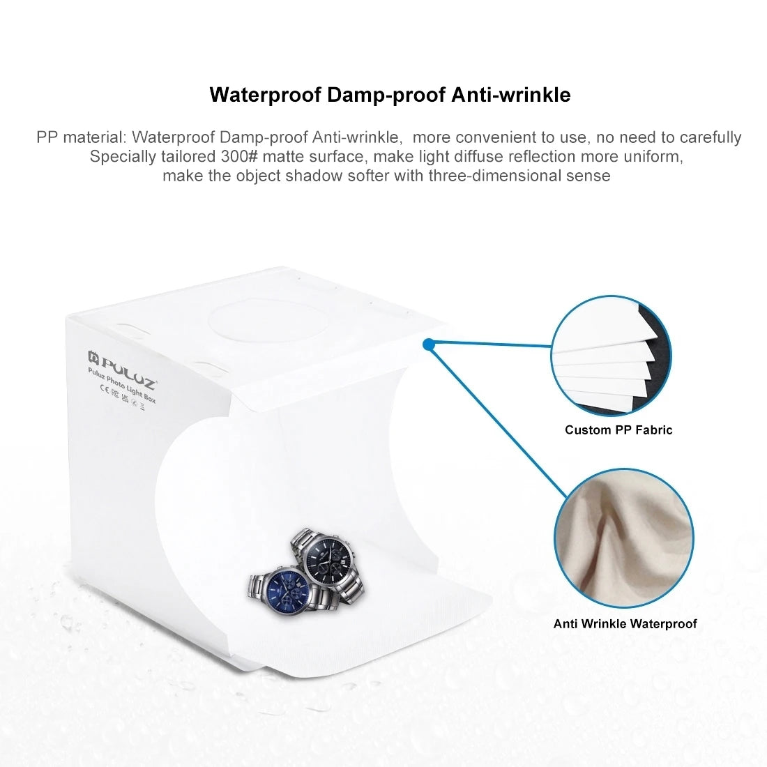 Small white Puluz folding light box lit from above with beaded bracelets inside, and a hand holding a phone showing the shot