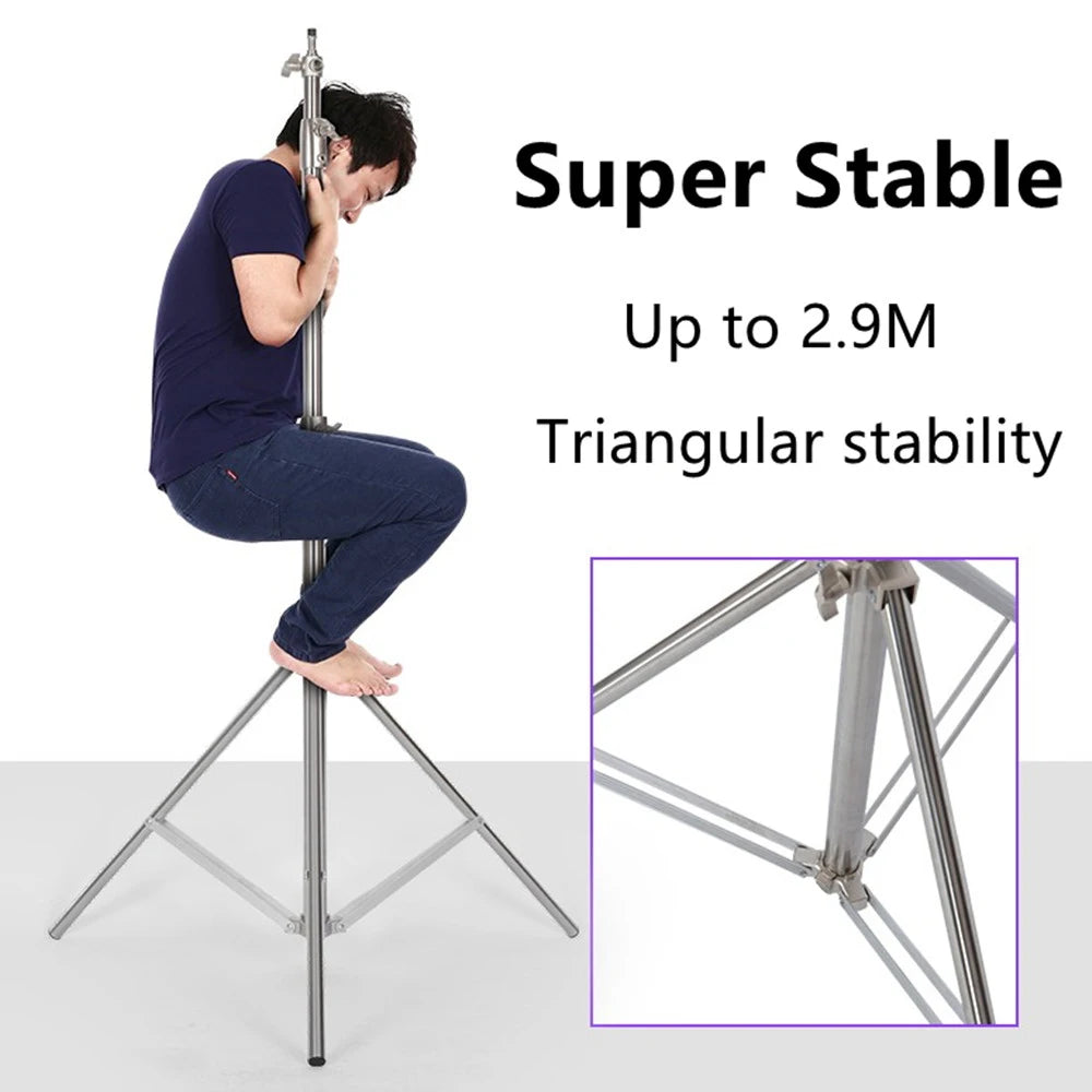 Man hugging the pole of a silver stainless steel light stand while sitting on it, with a close-up of the braced leg joint