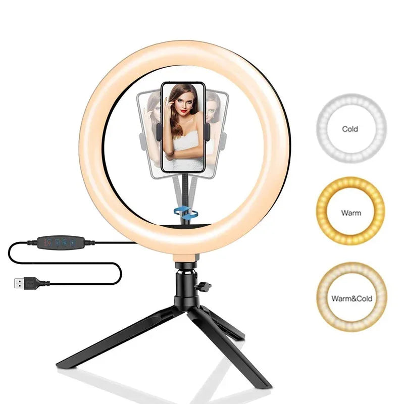 LED ring light on a small black tripod holding a phone on a makeup table, with a woman applying blusher behind it