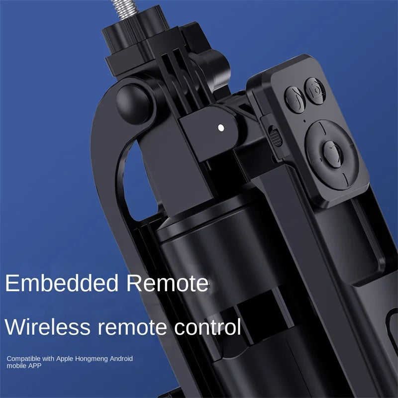 Black selfie stick tripod on a four-leg base holding a phone, with a detachable remote clipped to the pole