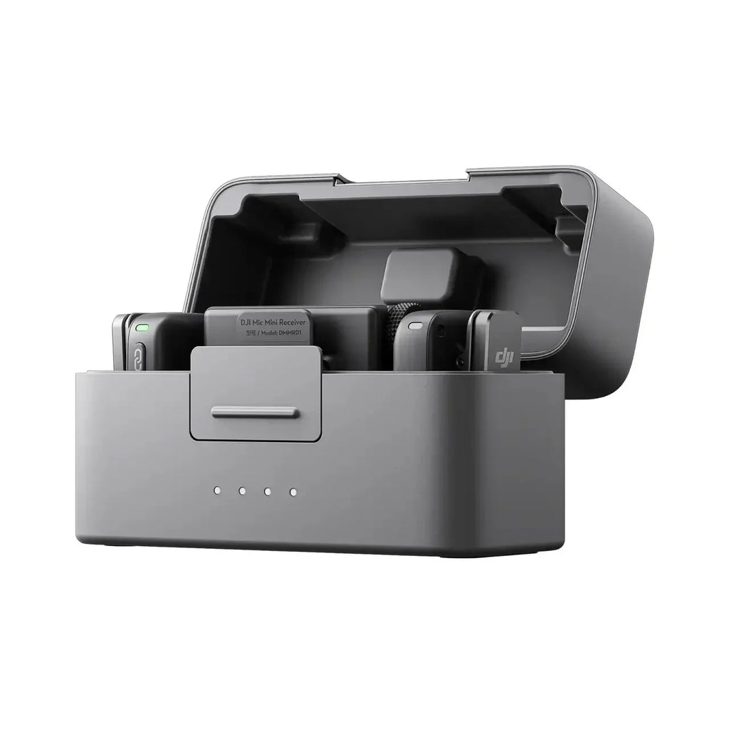 Black DJI Mic Mini charging case open, holding two small transmitters with gray furry windscreens