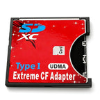 Red CompactFlash-size adapter with an SD card opening, labelled Type I UDMA Extreme CF Adapter, on dark stone