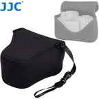 Contoured black soft camera pouch with a zip around the body and two small loops, shown closed on a white background