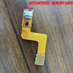 PSP Go console lying face up with an orange ribbon adapter attached at the left edge and a Memory Stick entry on screen