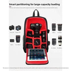 Black camera backpack with a red padded interior holding a DSLR, lenses and a tablet, shown open from the front
