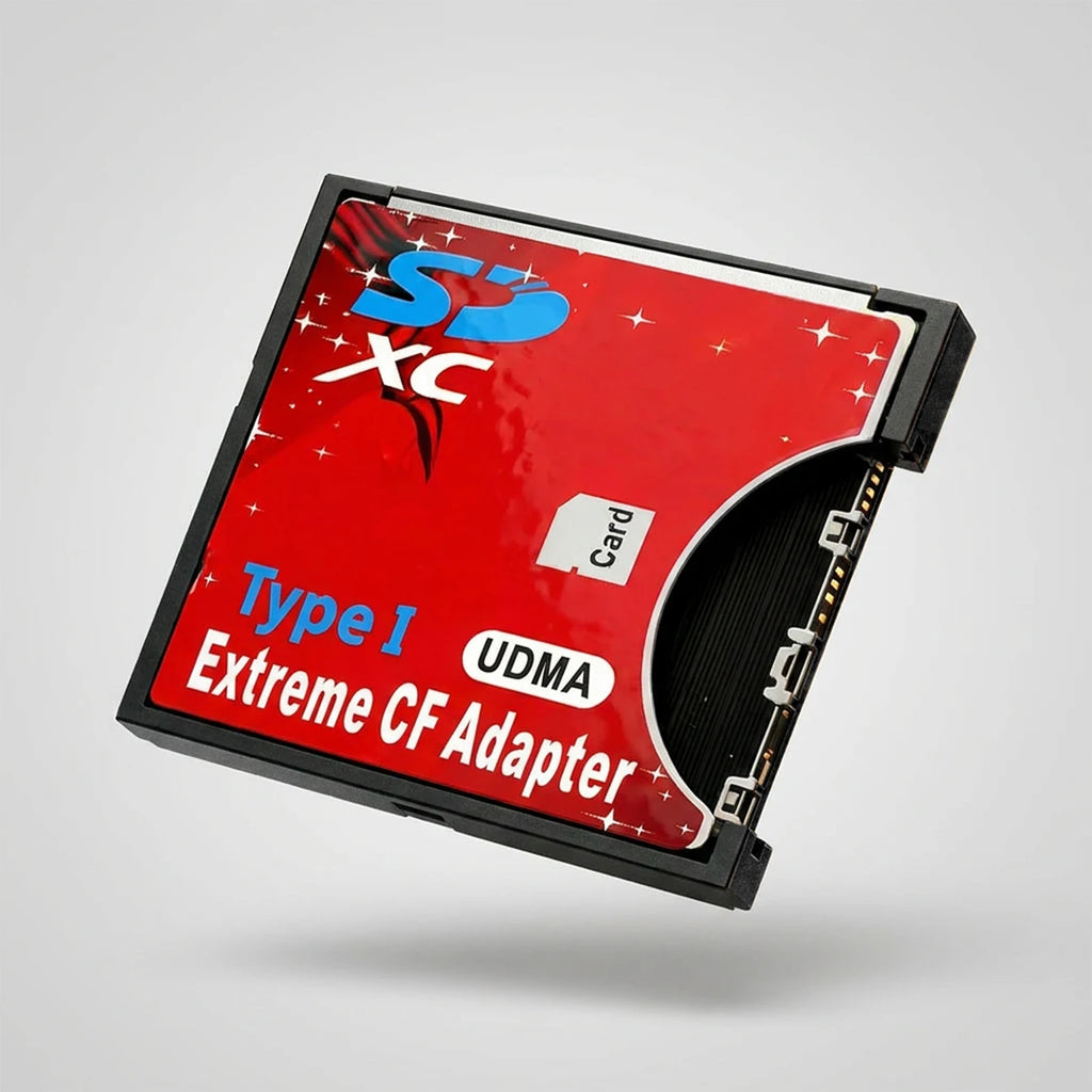 Red CompactFlash-size adapter with an SD card opening, labelled Type I UDMA Extreme CF Adapter, on dark stone