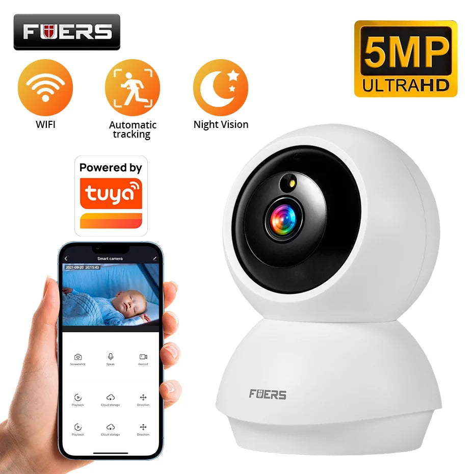 White Fuers pan-tilt indoor camera beside a hand holding a phone that shows a sleeping baby in the app