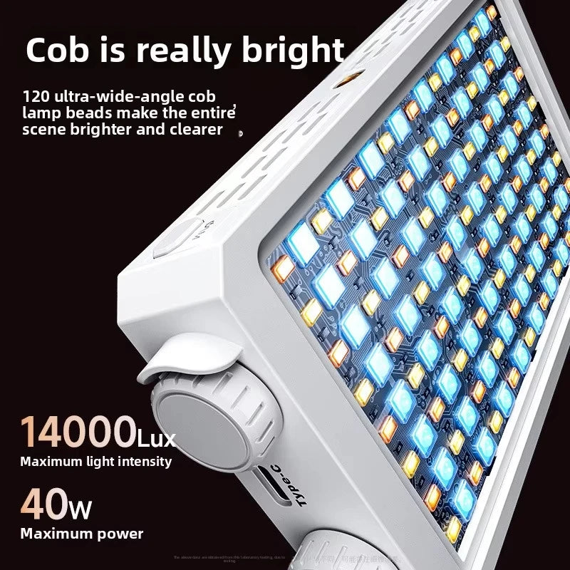 Two pocket-sized LED panel lights with control dials, one champagne and one grey, glowing warm white on a dark surface