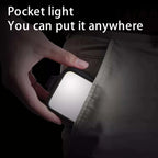 Square black LED panel light, front and back, with two dials, a phone clip, a cold shoe mount and a USB-C cable