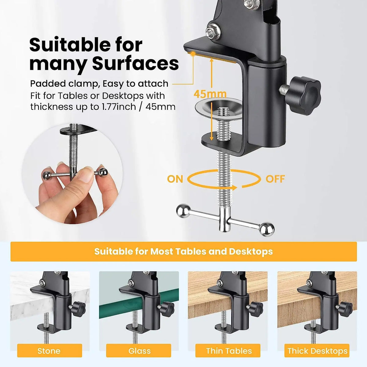Black spring-loaded desk arm clamped to a table holding a phone, with a remote, ball head, phone clip and clamp laid out