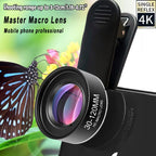 Black clip-on macro phone lens with a spring clip behind it, shown against a photo of a blue butterfly on flowers