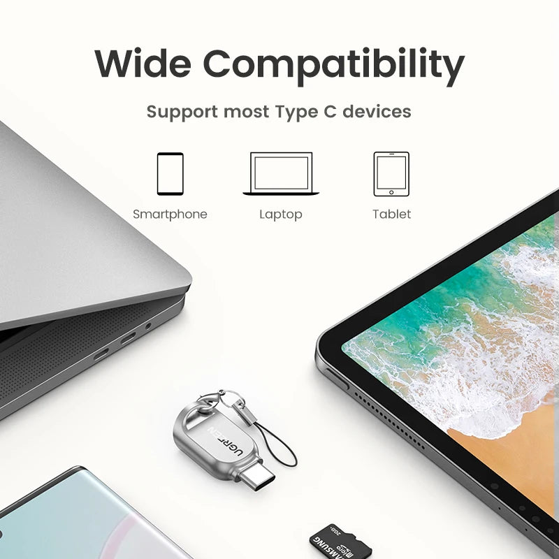 Small silver metal microSD card reader with a USB-C plug and a short wrist strap on a split ring