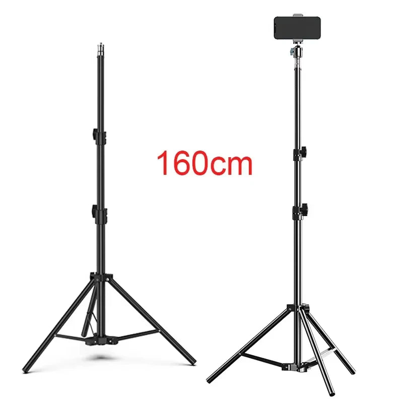 Two black telescoping tripod stands with spread legs, one bare and one holding a phone on a small ball head