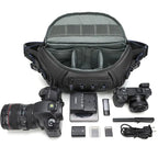 Black camera sling bag open from the top to show grey dividers, above three views holding a camera and lenses