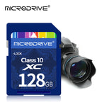 Four blue Microdrive Class 10 SD cards stepped in a row, with a Canon DSLR lens in the top corner