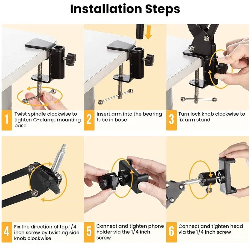 Black spring-loaded arm clamped to a table, holding a phone on a ball head, shown with a remote, a phone clip and a clamp