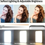 Black clip-on LED panel with warm and cool beads, shown clipped to a phone, mounted on a DSLR and clipped to a laptop