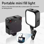 Square black LED panel light, front and back, with two dials, a phone clip, a cold shoe mount and a USB-C cable