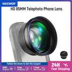 Black Neewer telephoto phone lens with a blue-rimmed front element, mounted on a greyed-out phone, its cap beside it
